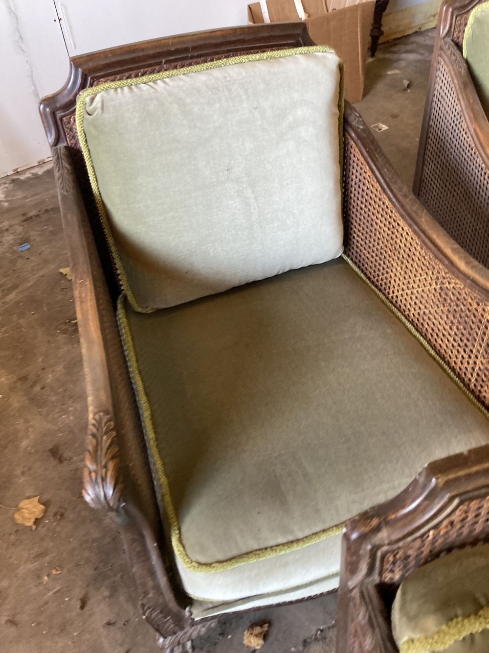 A 1920s carved beech four piece bergere suite